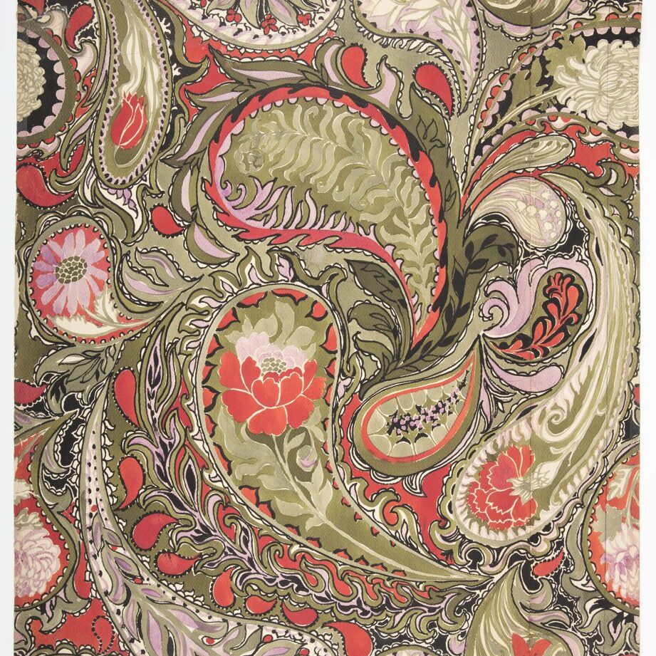 A close up of the fabric with red and green paisley design.
